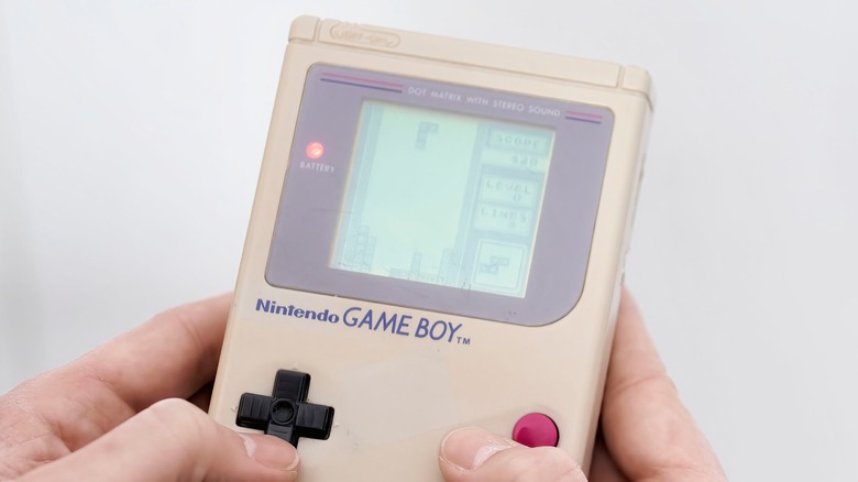 Person holding original Game Boy