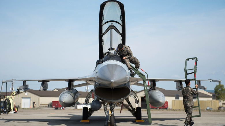 Personnel work on a A Republic of Korea Air Force F-16 on a flightline