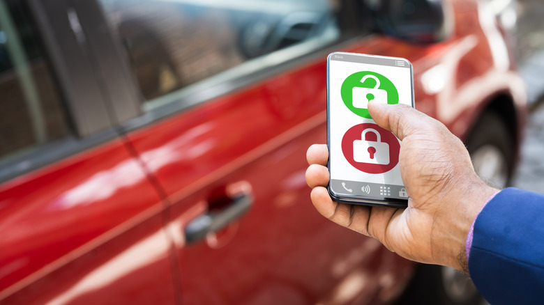 Person unlocking car with smartphone
