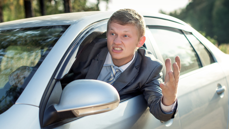 angry driver hanging out his window