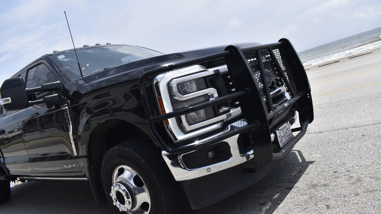 Close-up of a black pickup truck with a grill guard fitted to the front