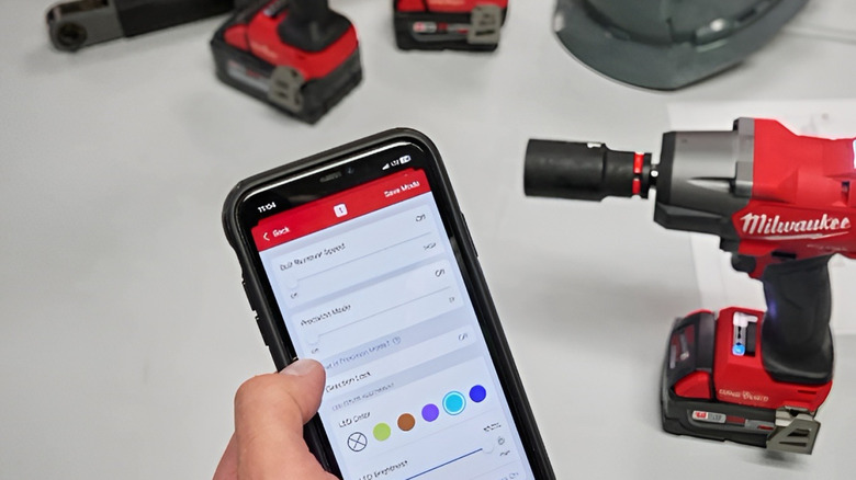 Person holding up phone app that controls their Milwaukee One Key tool