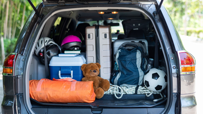 A car trunk packed with luggage.