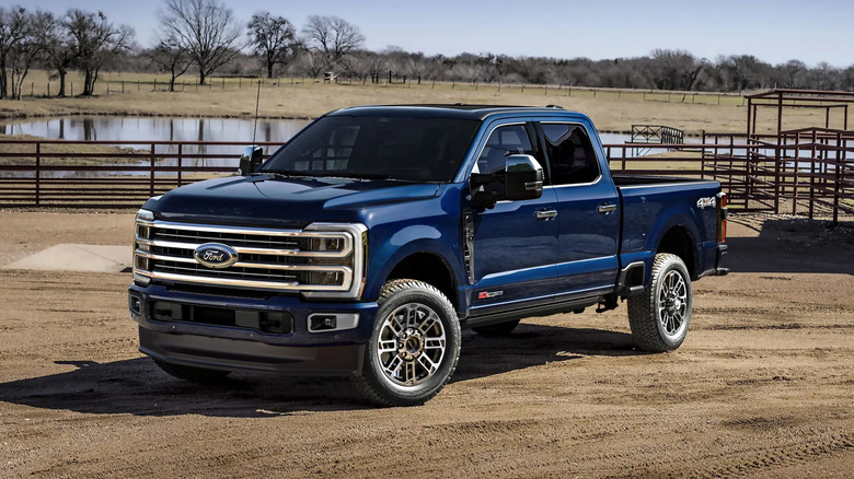 2025 Ford Super Duty Power Stroke diesel truck on ranch, front-left 3/4 view