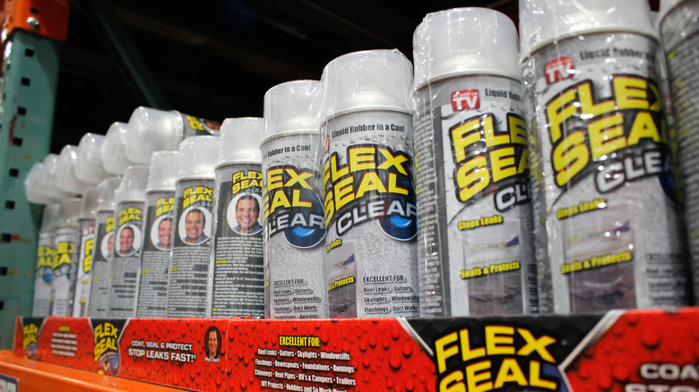 A row of several Flex Seal aerosol cans on a shelf