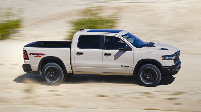 Beige 2025 Ram 1500 Rebel driving in desert