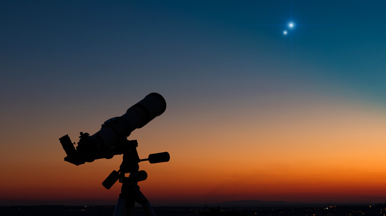 Telescope against twilight sky