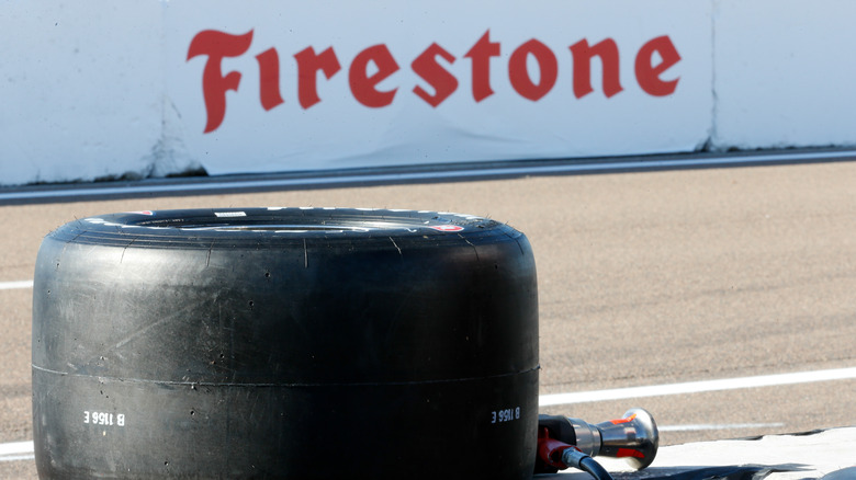 Firestone tire with logo in the background at an IndyCar event