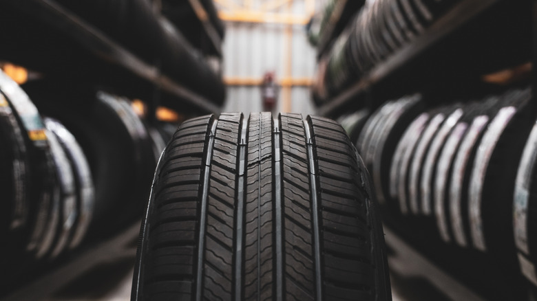 New tire with a rack of tires in the background