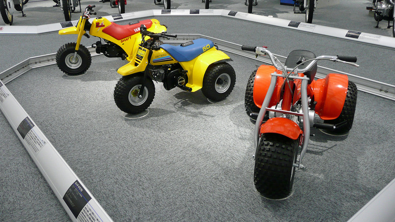 Honda ATC70, Suzuki ALT50 Trailbuddy, and Yamaha Tri-Zinger on display