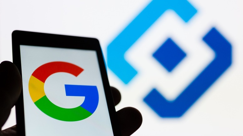 Google logo on phone near Roskomnadzor logo background