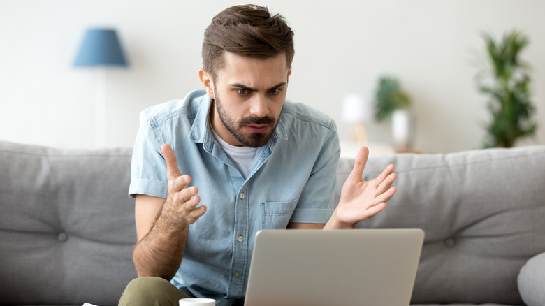 man frustrated on computer