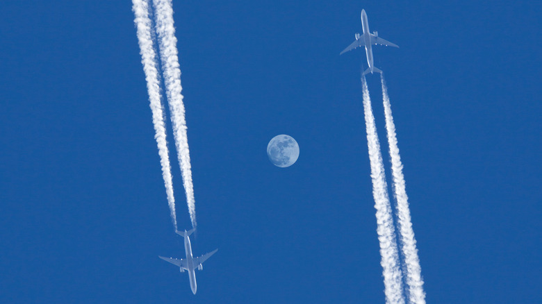 Two airplanes flying in opposite direction.