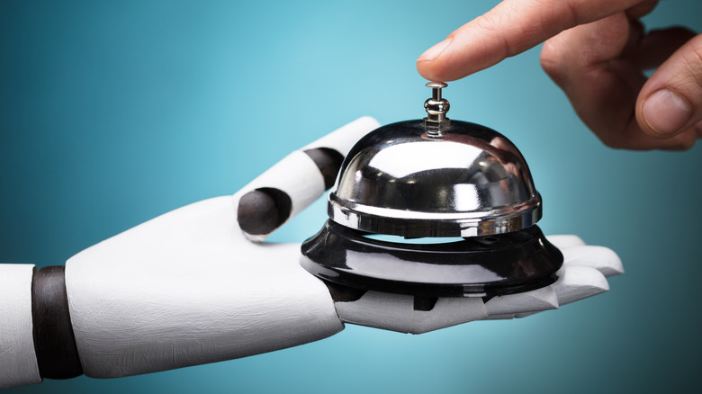 person ringing bell held by robot