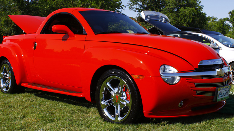 A red Chevy SSR parked outside. 
