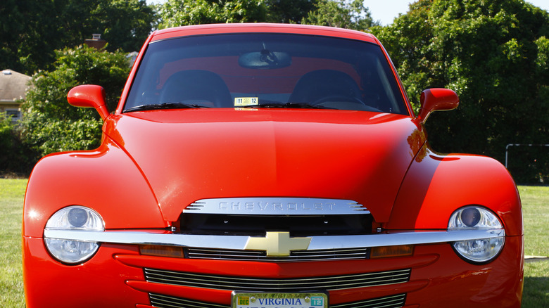 A red Chevy SSR parked outside. 