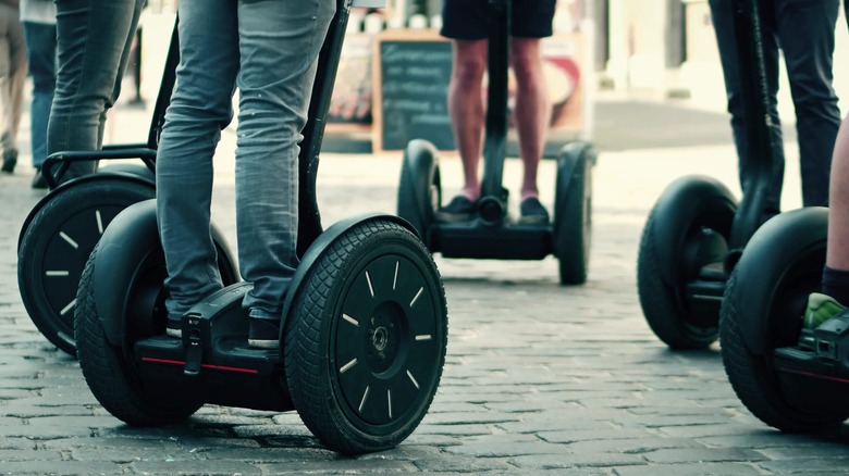 segway riders on urban street