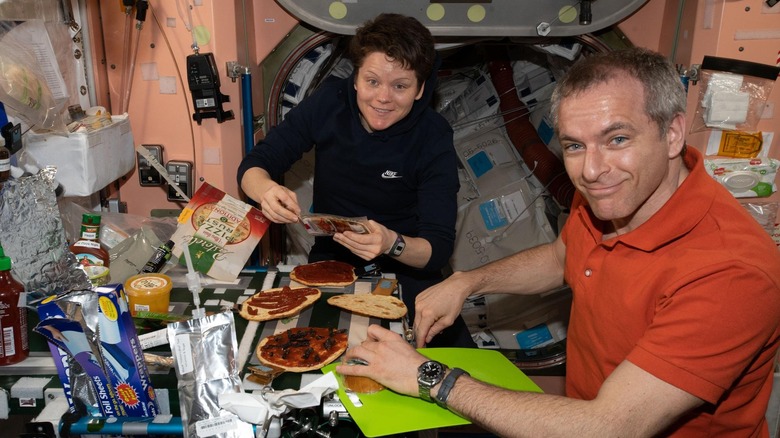 Astronauts preparing to eat personal pizzas on the ISS 