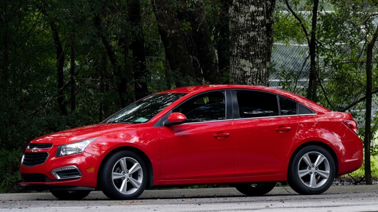 A red Chevy Cruze parked on the road