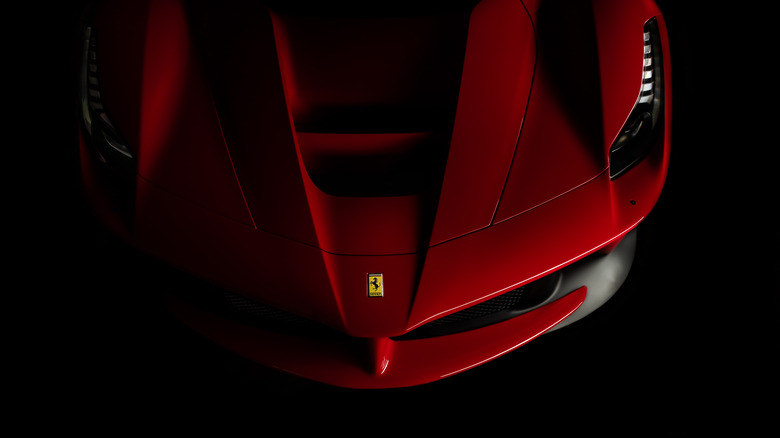 Front end of a red Ferrari in shadow