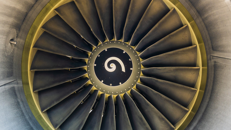 close-up of a jet engine intake fan, with a spiral painted on
