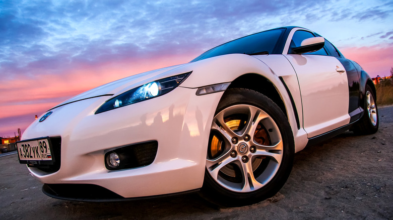 A two-tone Mazda RX-8 cruising the streets