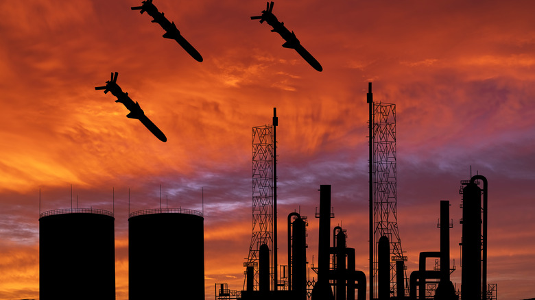 missiles over a power plant at sunset