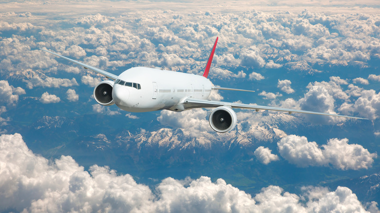 Airplane flying above clouds
