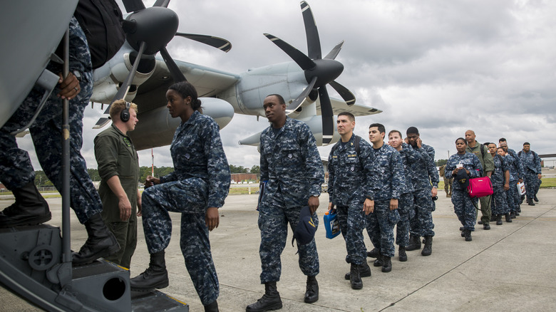 U.S. Marines and Sailors board an aircraft at Cherry Point