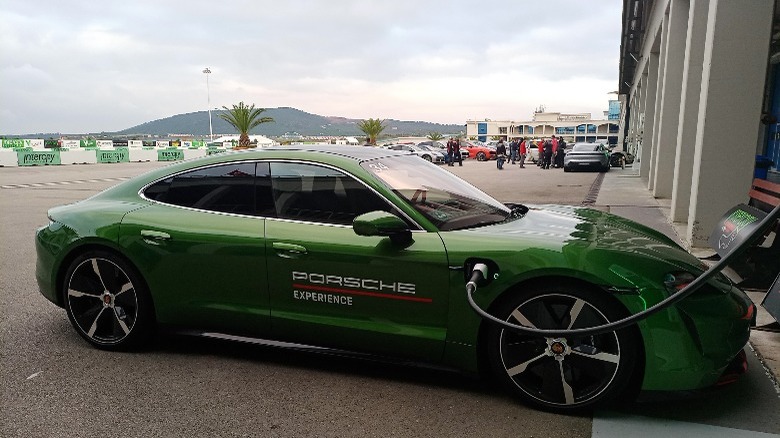 electric porsche parked at charger