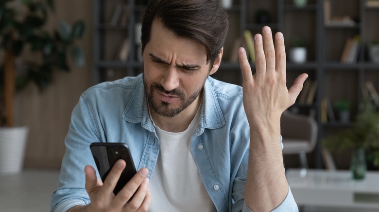 Person frustrated at phone
