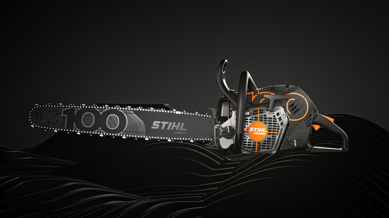 A black Stihl MS 500i Centennial Edition chainsaw against a black studio background
