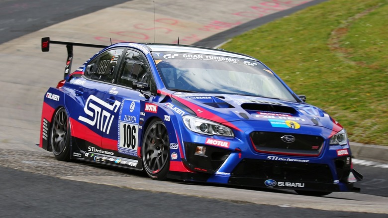 Front 3/4 view of Subaru WRX STI NBR race car racing on the Nurburgring