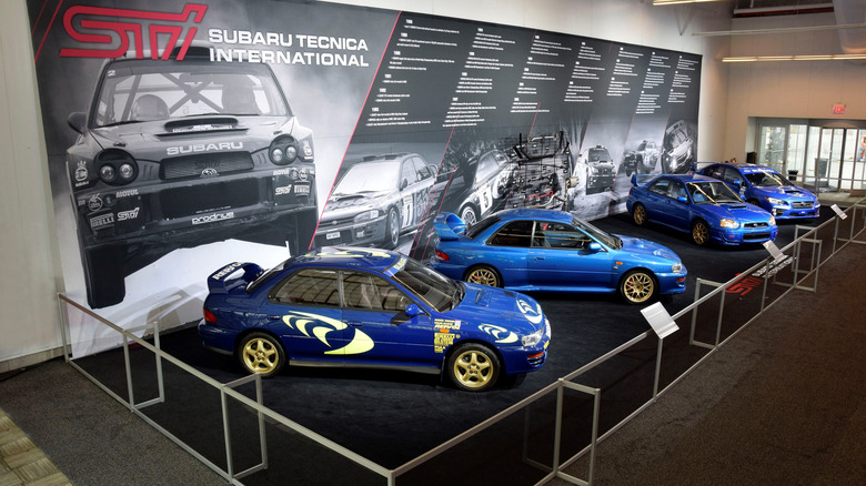 Overhead view of Subaru WRX STI heritage display, showing several Impreza STI variations