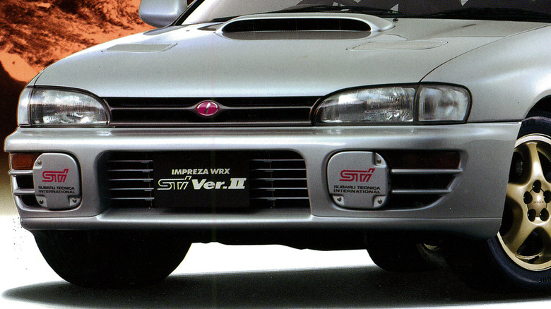 Close up view of grille and front bumper on Subaru WRX STI with the pink logo