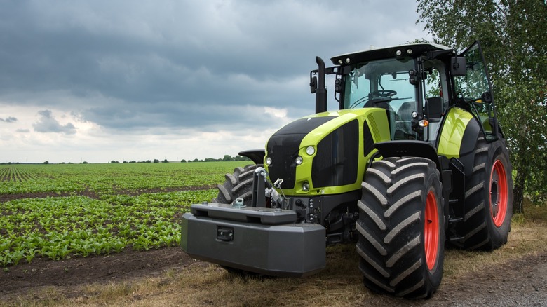 A new green tractor stands near the field