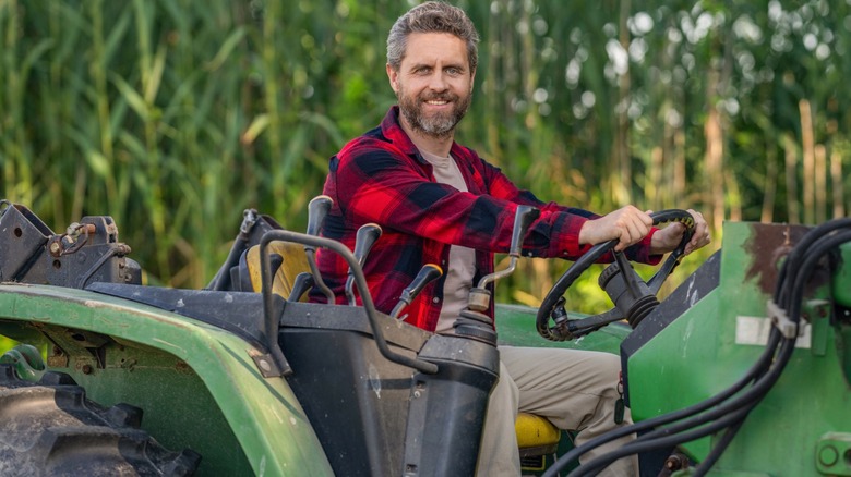 A happy farmer on a tractor