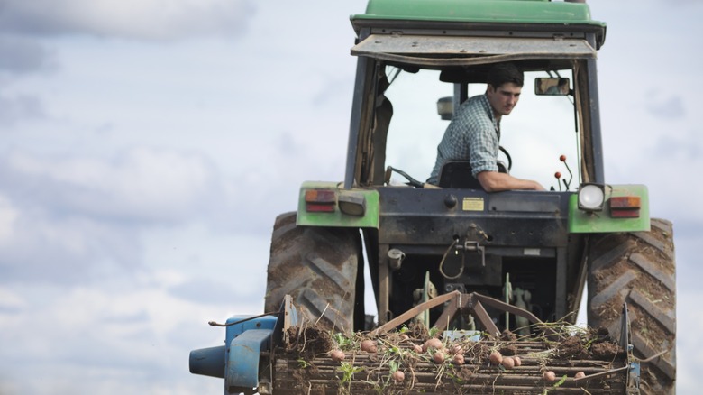 A farmer on a tractor doing field work