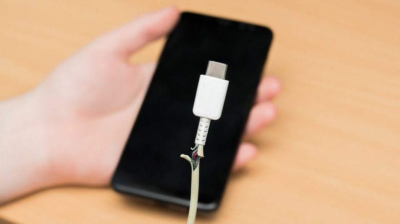 frayed USB cable and phone