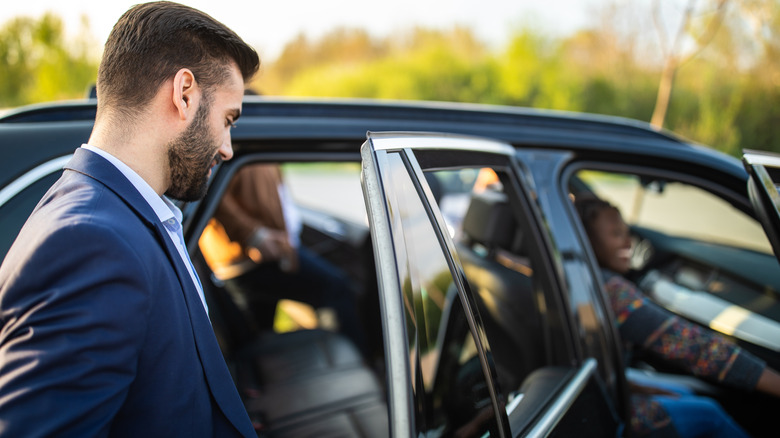 Person opens car rear door