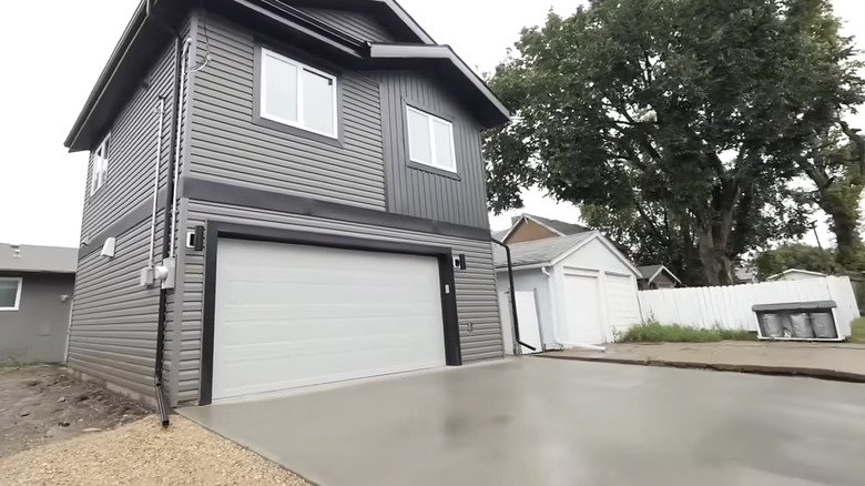 A small home with a garage and driveway