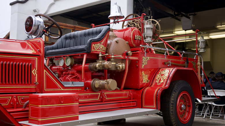 Old fire truck featuring open cab design.