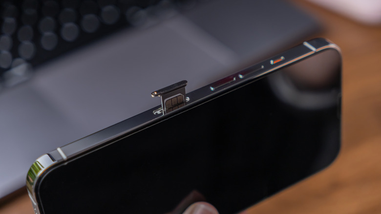 iPhone on its side with SIM tray ejected