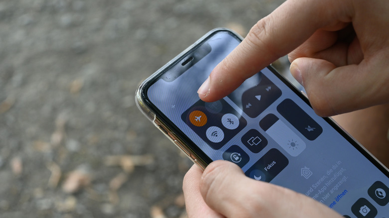Person tapping on airplane mode icon