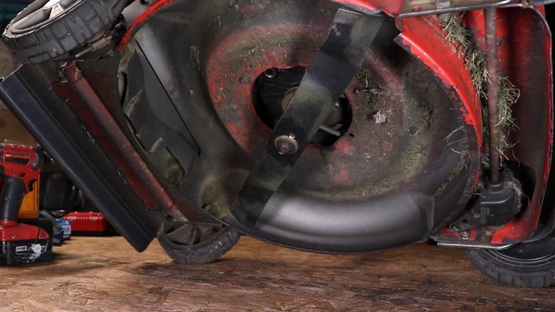 A lawn mower tilted on its side.
