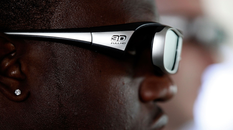 A man wears active 3D glasses