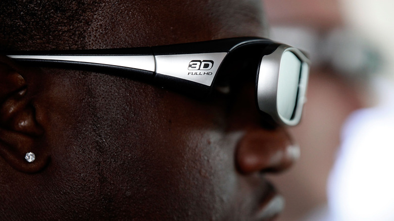 A man wears active 3D glasses