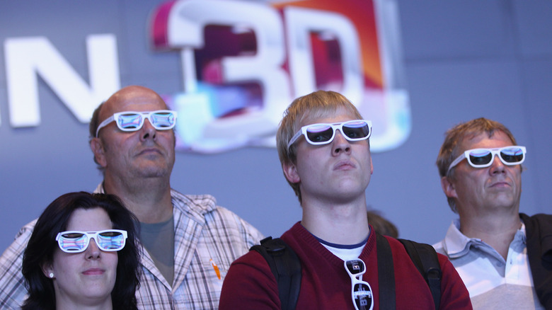 Visitors watch a 3D TV at a tech expo