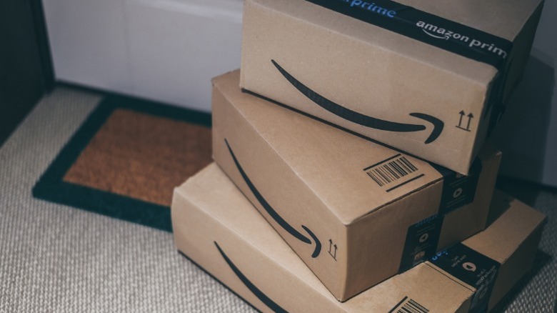 Amazon packages stacked on a doorstep