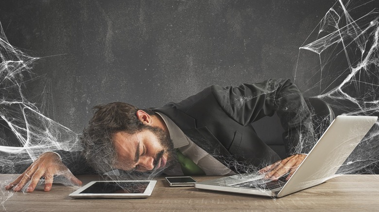 Man using tech covered in cobwebs